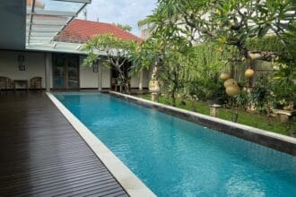 Kolam renang pribadi dan taman asri di dalam rumah mewah Teras Ayung Residence dekat Living World Mall Bali.